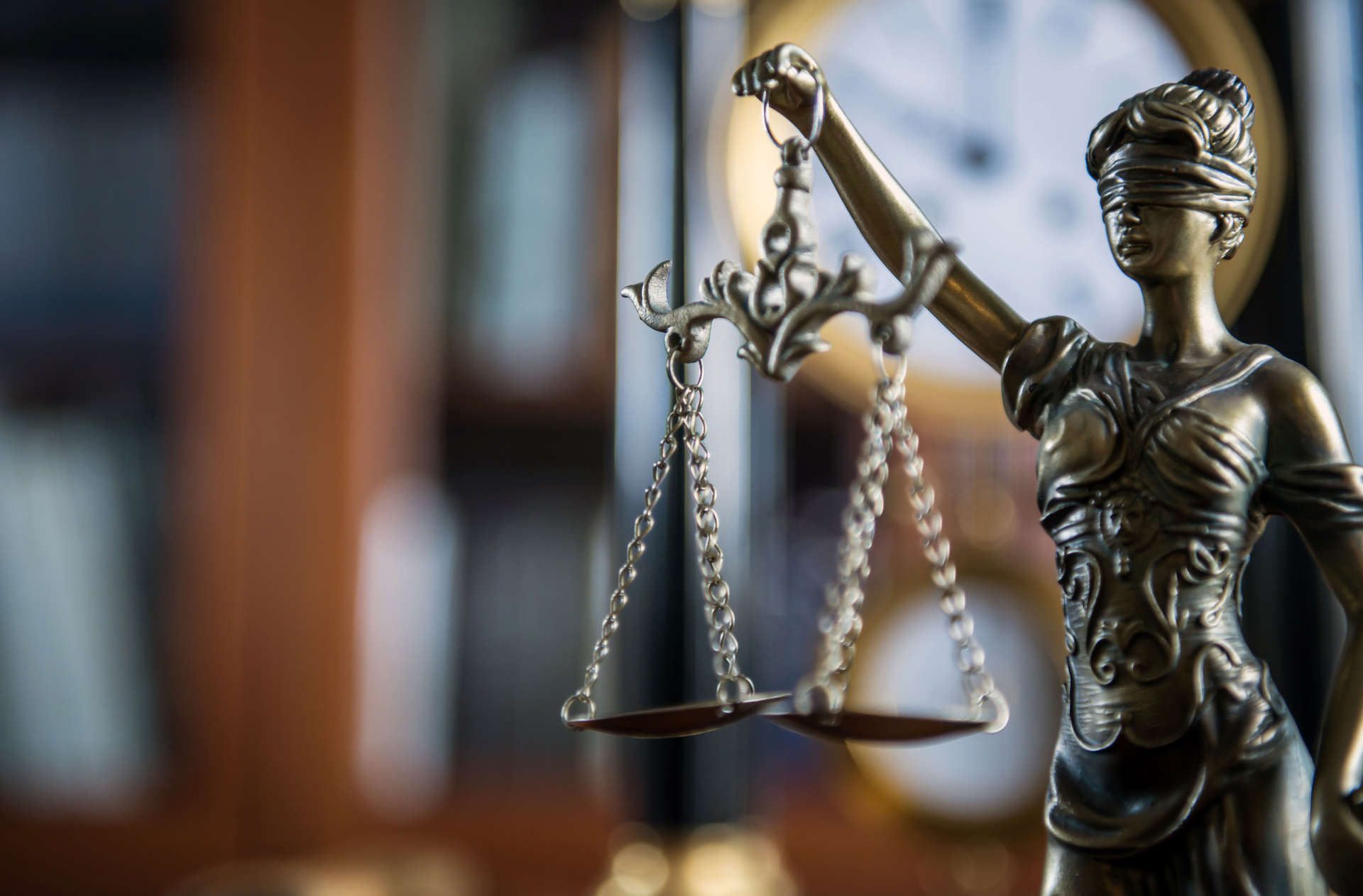 selective-focus-photography-of-female-figurine-holding-balance-scale